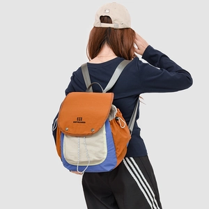 Detailed back view of outdoor hiking backpack with orange and blue contrast colors