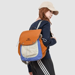 Detail view of the side elastic drawstring and colorful nylon fabric on outdoor backpack