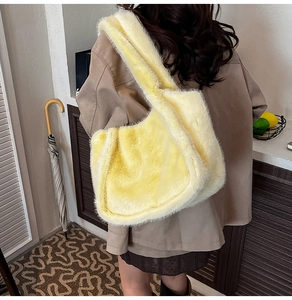 Macro detail of plush yellow faux fur texture and seamless strap on a large tote bag