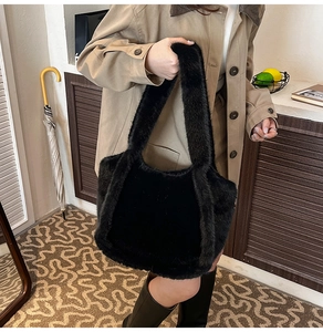 Detail of soft black faux fur tote bag showing plush texture and spacious handle design