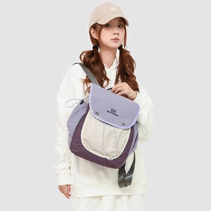 Detail of multi-color outdoor backpack with drawstring closure and purple top flap