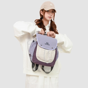 Detail of the tricolor patchwork hiking backpack with flap cover and drawstring closure