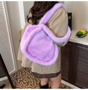 Macro view of purple faux fur tote bag showing plush texture and wide shoulder strap