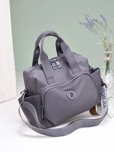 Waterproof large capacity grey-purple handbag with wide strap shown in a studio setting