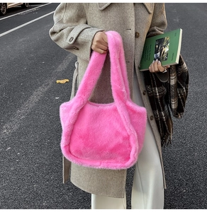 Detail of bright pink faux fur tote bag with plush texture and matching wide shoulder strap