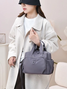 Grey waterproof nylon handbag with adjustable strap and large capacity for daily use