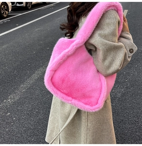 Close-up of bright pink faux fox fur texture on a soft and oversized shoulder tote bag