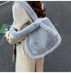 Detail of soft faux fur tote bag in light grey texture with wide plush shoulder strap