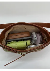 Interno spazioso della borsa a quadri retrò con oggetti quotidiani e tasca con zip