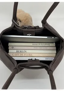 Deep brown leather tote bag interior showing large capacity for laptop and books