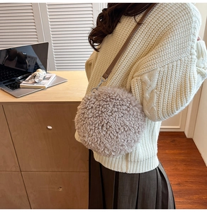 Plush lamb wool small round crossbody bag shown with a minimalist sweater and skirt