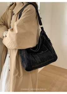 Detail of vintage washed denim tote bag showing macro texture and cargo pocket design