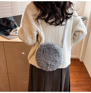 Detailed view of grey fuzzy sherpa round crossbody bag with soft faux fur texture