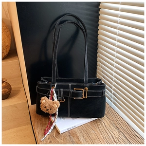 Detail view of black underarm bag featuring contrast white stitching and retro gold buckle