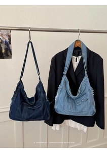 Detail of large denim tote bags with frayed edges and pockets in dark and light blue