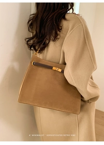 Gros plan d'un grand sac cabas en daim camel avec bandoulière en cuir et fermoir doré