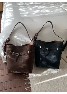 Detail of vintage suede tote bags with belt buckle décor and floral silk scarf accents