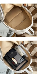 Interior view of white backpack showing spacious main compartment and pockets for storage