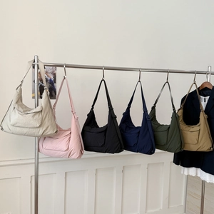 Versatile nylon tote bags in six colors shown hanging on a rack for daily use