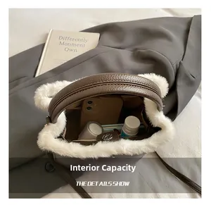 Interior view of winter plush handbag showing capacity for phone and cosmetics