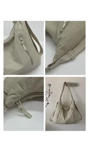 Détails du sac fourre-tout en nylon beige montrant zips, coutures et bandoulière réglable