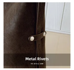 Macro shot of dark brown leather texture with silver metal rivets and strap details