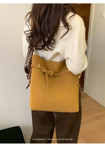 Retro mustard yellow large capacity bucket bag with decorative scarf on model