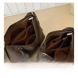 Detail view of large tote bag interior showing multiple zipper compartments and pockets