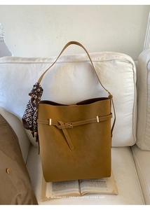 Minimalist caramel faux suede tote bag detail with decorative printed silk scarf on handle