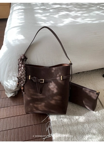 Detail of dark brown faux suede tote bag set with matching pouch and patterned silk scarf