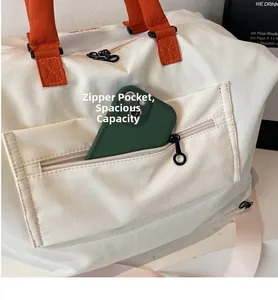 Detailed close-up of a front zipper pocket on a canvas bag showing large storage capacity