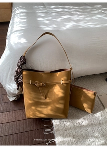 Detail of mustard yellow suede tote bag with matching pouch and patterned silk scarf