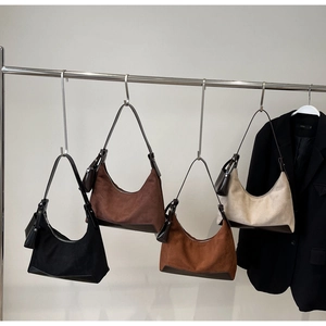 Four hobo bags in suede and leather finishes with mini pouches in assorted earthy tones