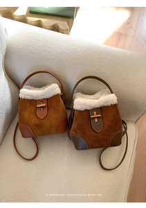 Detail of vintage brown bucket bags with suede texture and white faux fur trim on sofa