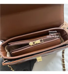 Close-up of brown quilted leather bag interior with smooth zipper and gold hardware
