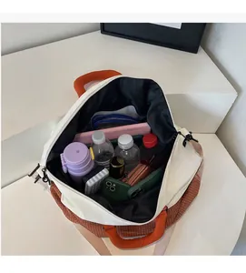 Detailed view of spacious interior storage with water bottle and phone in large tote bag