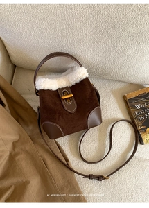 Detailed close-up of retro suede crossbody bag with plush faux fur trim and gold metal lock