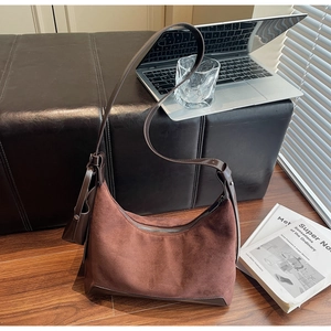 Detail of caramel suede tote bag with matching mini pouch on strap and zipper closure