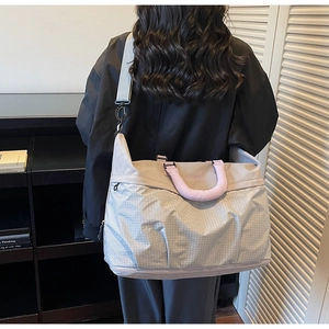 Detailed back view of a large capacity travel tote bag with gray and purple plaid design