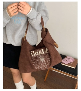Detail of vintage brown suede tote bag featuring white daisy embroidery and MapiLi logo