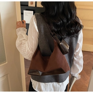 Detail of dark coffee hobo bag featuring matte suede and glossy leather splicing texture