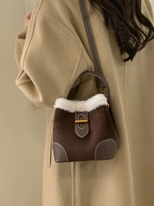 Retro brown suede bucket bag with white faux fur trim and gold twist lock closure