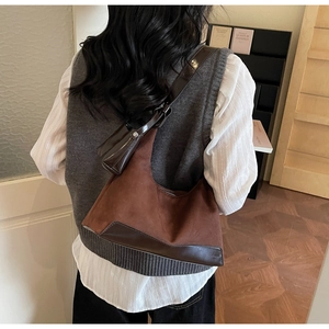 Detail view of brown matte suede tote bag with matching leather coin purse on the strap