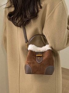 Vintage brown suede bucket bag with white faux fur trim and gold twist-lock buckle
