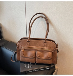 Detail of brown vintage tote bag showing two front flap pockets and smooth leather texture