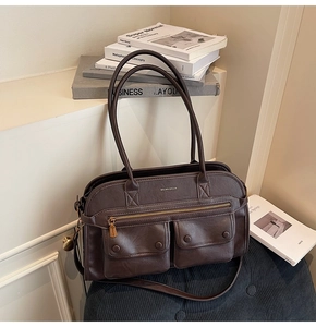 Detail of retro dark brown tote bag with twin snap-button pockets and leather texture
