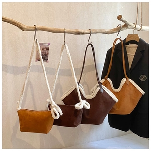 Detail of suede and faux fur patchwork tote bags in mustard yellow, brown, and camel shades