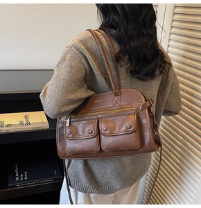 Close-up of brown retro tote bag showing textured faux leather and pocket details