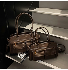 Detail of dark brown leather tote bags in two sizes with front pockets and metal buckles
