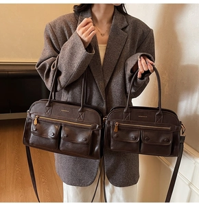 Close-up of vintage brown leather tote bags in two sizes with magnetic buckle pockets